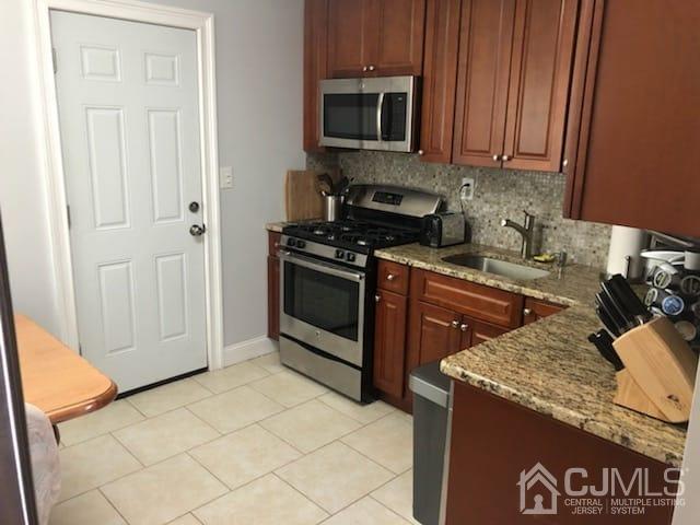9 Richmond Road Edison, NJ 08817 - Photo 3 of 15 a kitchen with stainless steel appliances granite countertop a stove a sink and a microwave