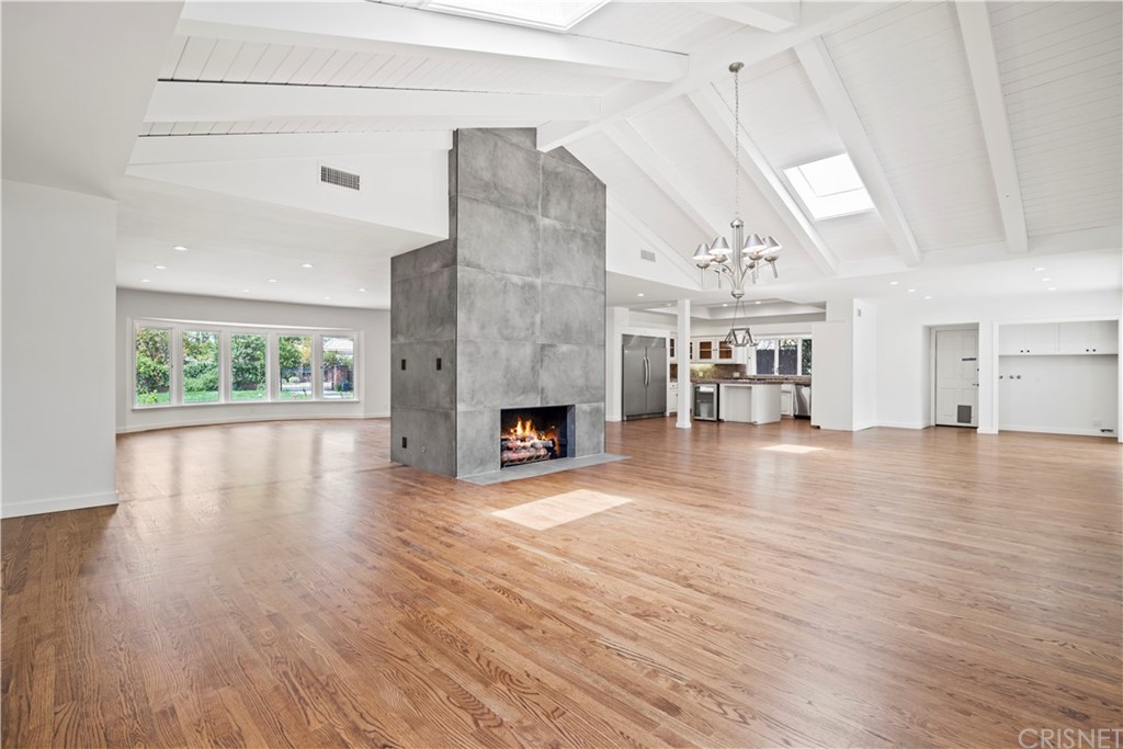17220 Gresham Street Northridge, CA 91325 - Photo 16 of 57 a view of a livingroom with wooden floor and a fireplace