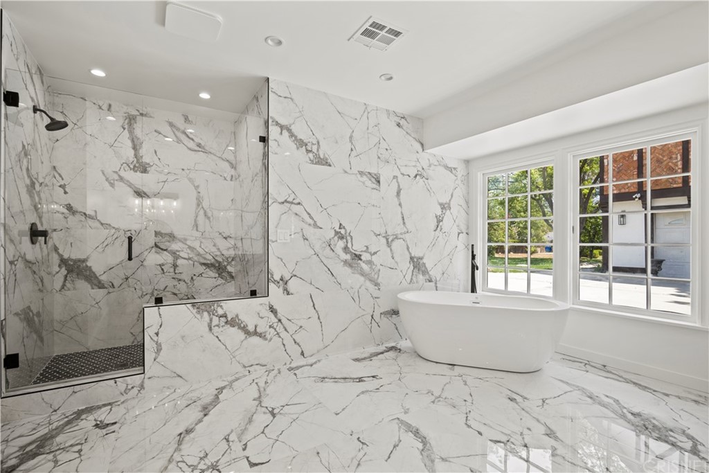 17220 Gresham Street Northridge, CA 91325 - Photo 24 of 57 a bathroom with a bathtub and a shower