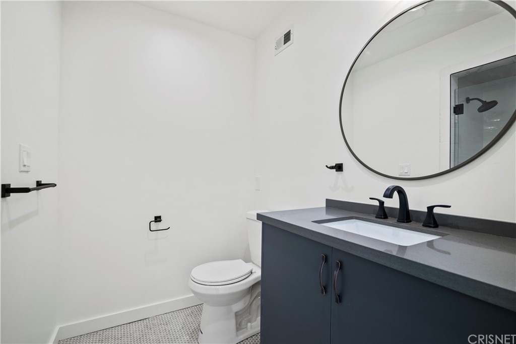 17220 Gresham Street Northridge, CA 91325 - Photo 26 of 57 a bathroom with a sink a toilet and a mirror