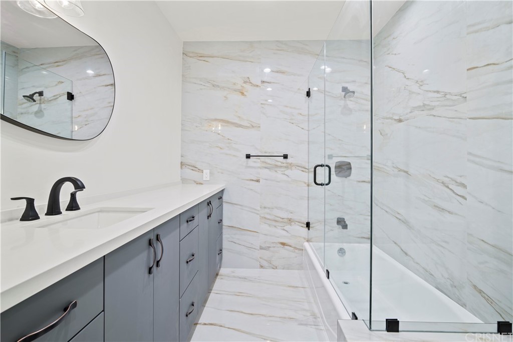 17220 Gresham Street Northridge, CA 91325 - Photo 28 of 57 a bathroom with a double vanity sink mirror and bathtub