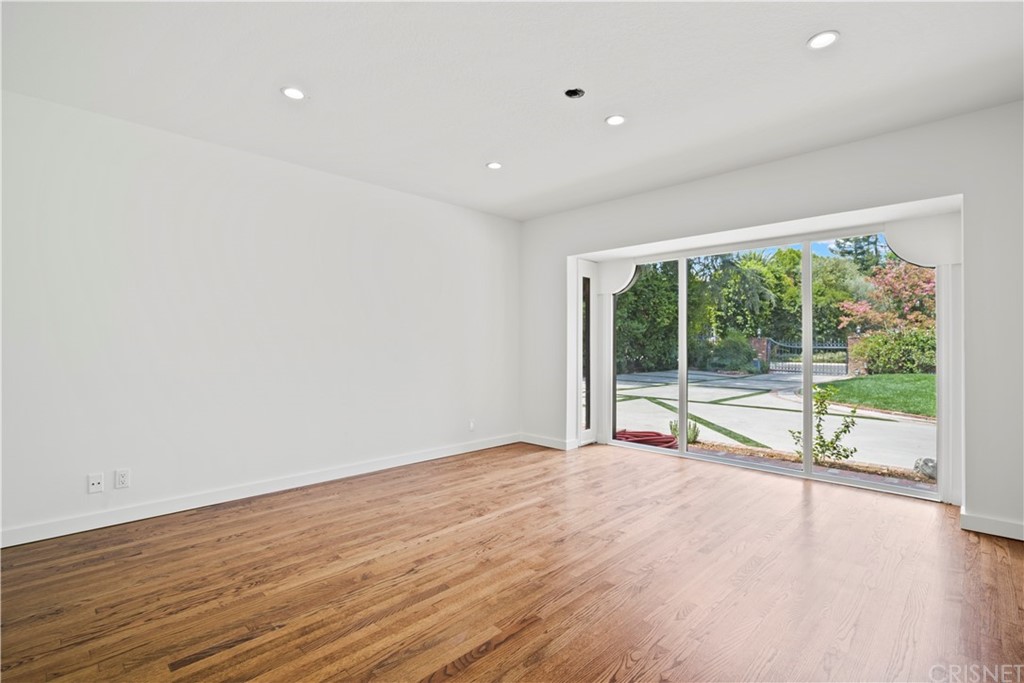 17220 Gresham Street Northridge, CA 91325 - Photo 29 of 57 a view of an empty room with wooden floor and a window