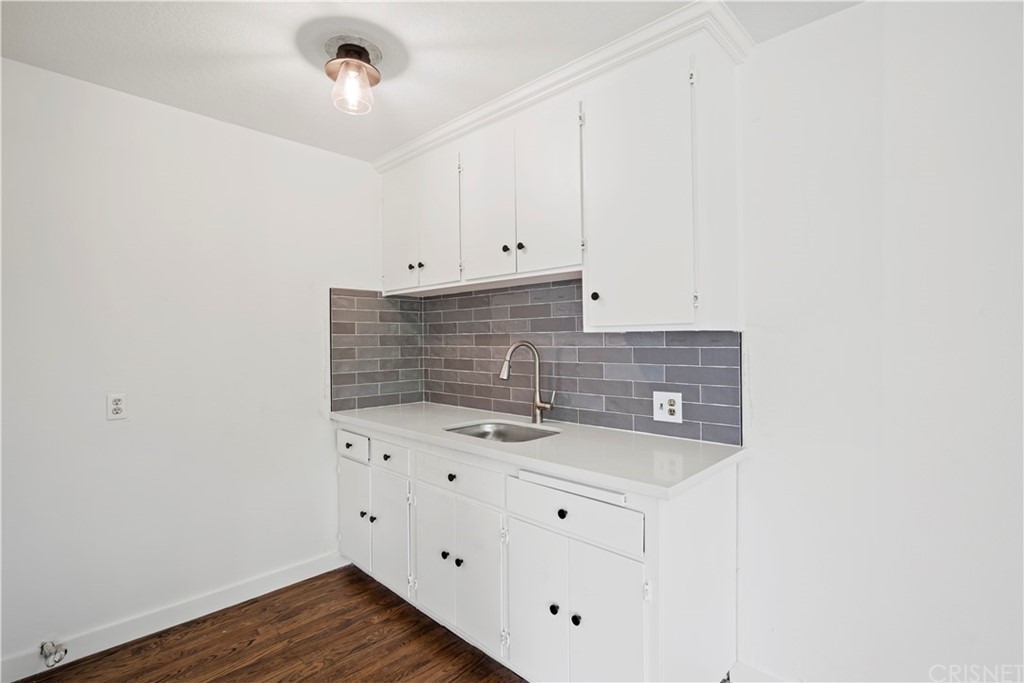 17220 Gresham Street Northridge, CA 91325 - Photo 52 of 57 a view of cabinets and wooden floor