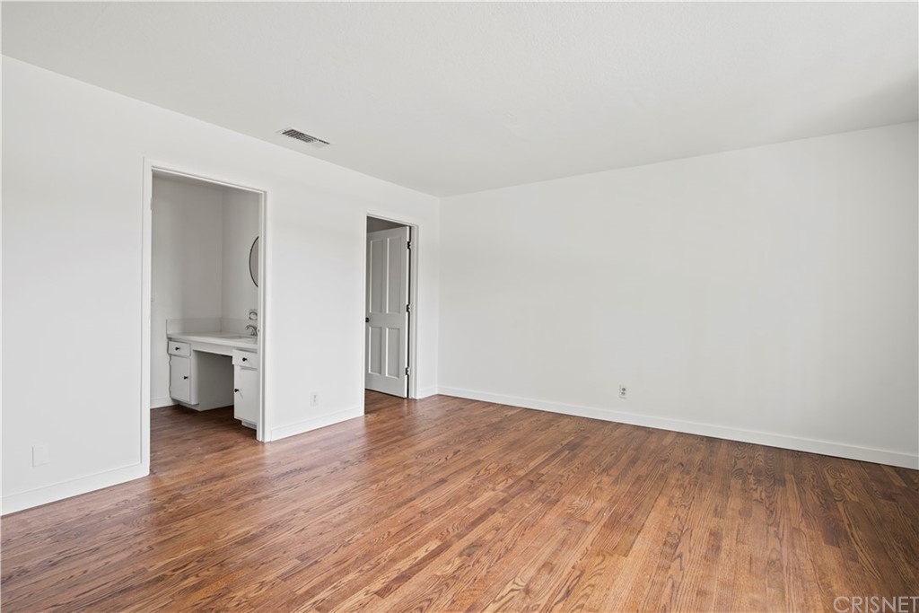 17220 Gresham Street Northridge, CA 91325 - Photo 54 of 57 a view of an empty room with a window and wooden floor
