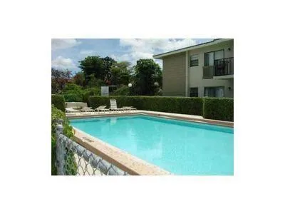 a view of a swimming pool with a yard