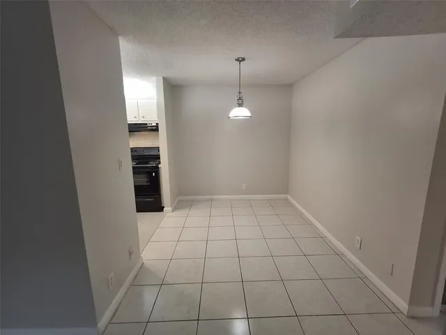 wooden floor in an empty room and a bathroom