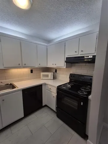 a kitchen with stainless steel appliances granite countertop a stove and a sink