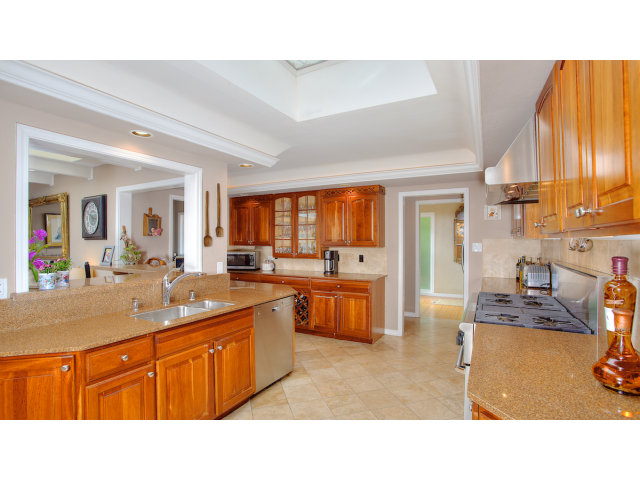 3 Spring Valley Lane Millbrae, CA 94030 - Photo 8 of 16 a kitchen with stainless steel appliances kitchen island granite countertop a sink and cabinets