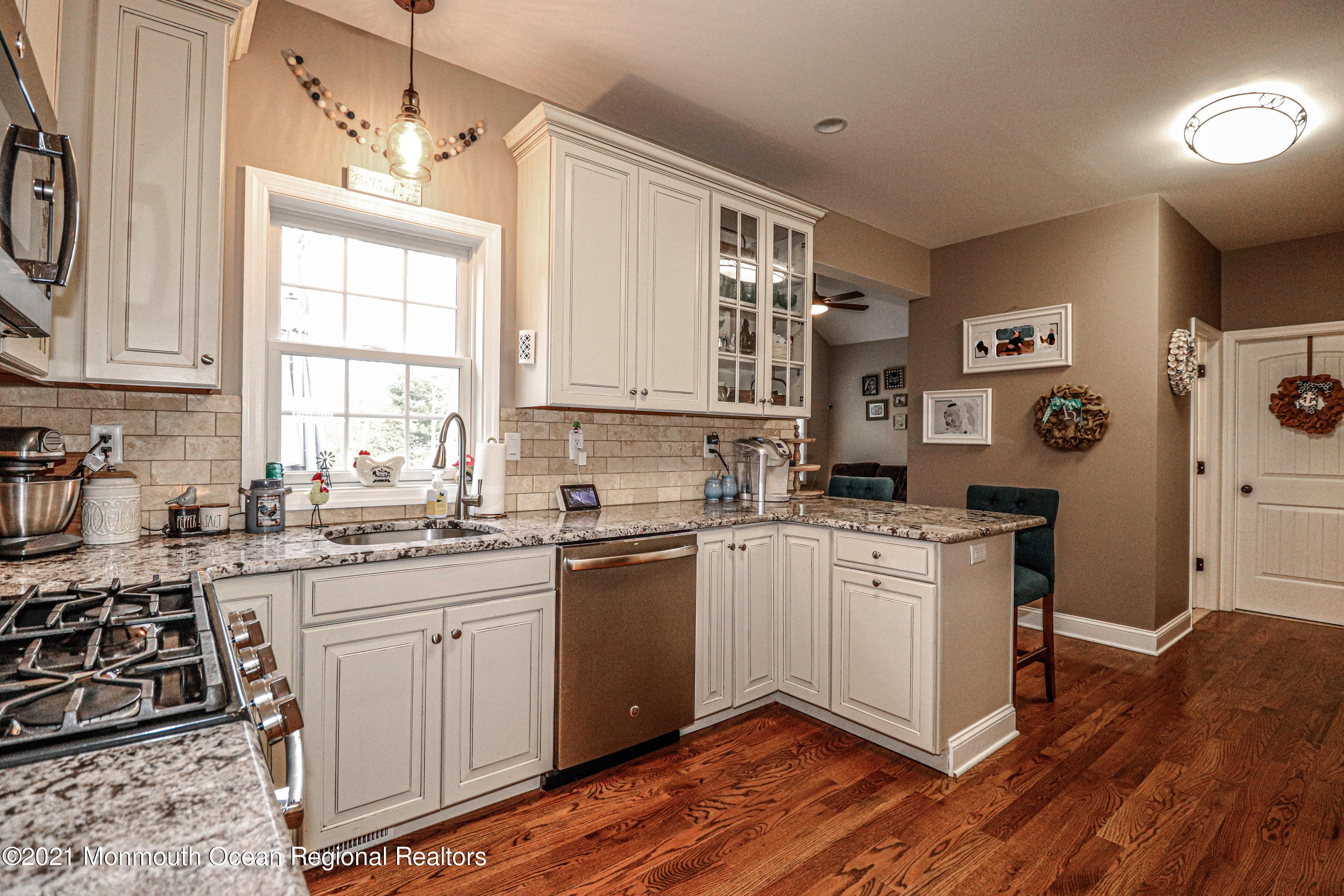 10 Letts Landing Road Waretown, NJ 08758 - Photo 14 of 51 a kitchen with stainless steel appliances granite countertop a stove top oven a sink dishwasher and white cabinets with wooden floor