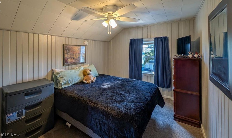 41 Poplar Street Huron, OH 44839 - Photo 17 of 37 Bedroom with wooden walls, carpet floors, ceiling fan, and vaulted ceiling