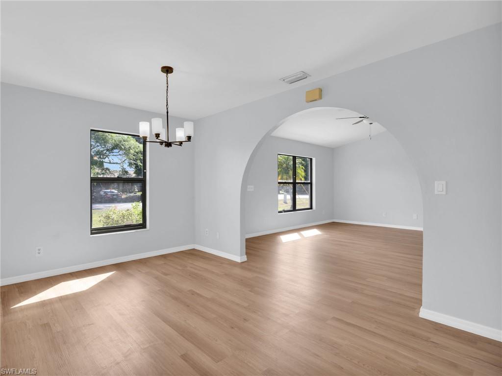 4991 18th Court Southwest Naples, FL 34116 - Photo 11 of 36 a view of an empty room with window and wooden floor
