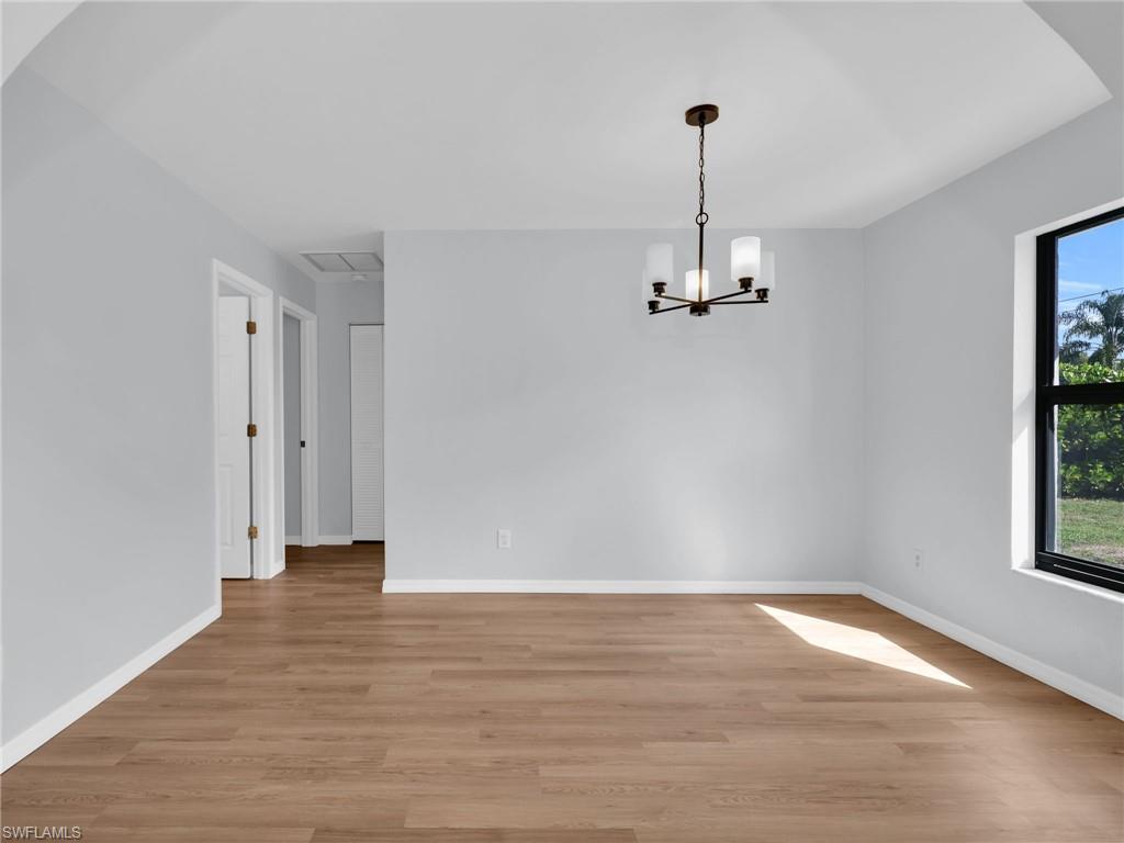 4991 18th Court Southwest Naples, FL 34116 - Photo 12 of 36 a view of empty room with wooden floor and window