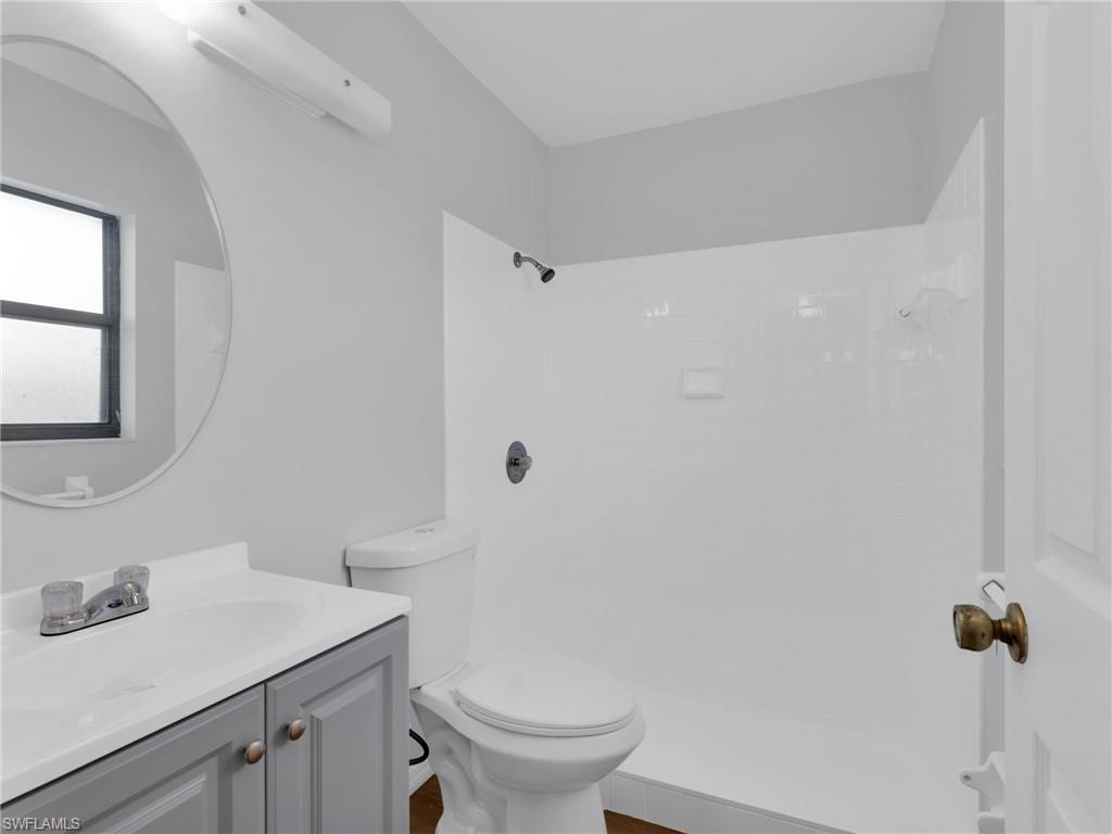 4991 18th Court Southwest Naples, FL 34116 - Photo 17 of 36 a bathroom with a sink toilet and vanity
