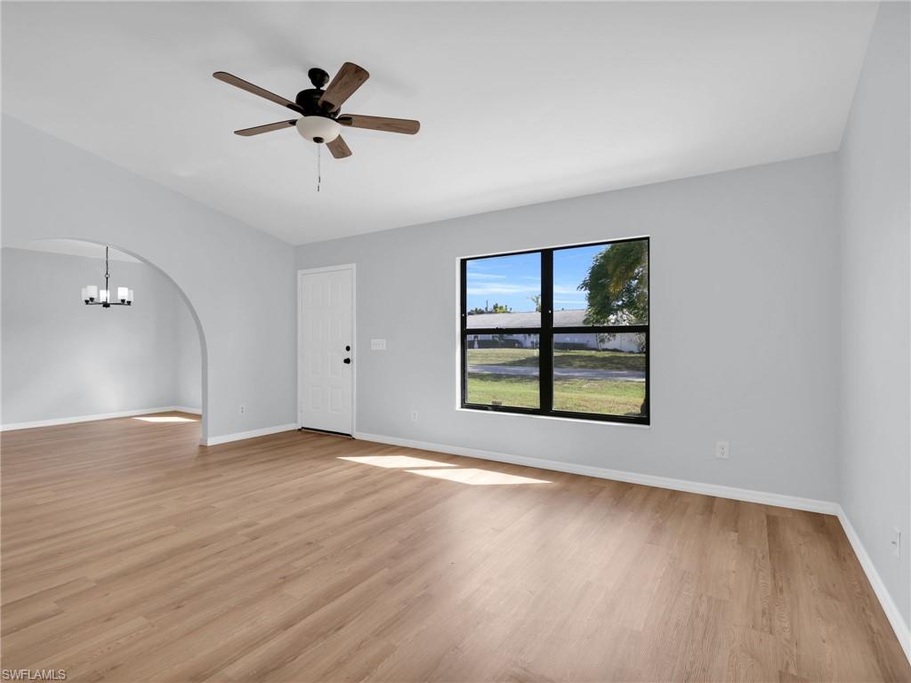 4991 18th Court Southwest Naples, FL 34116 - Photo 2 of 36 wooden floor in an empty room with a window