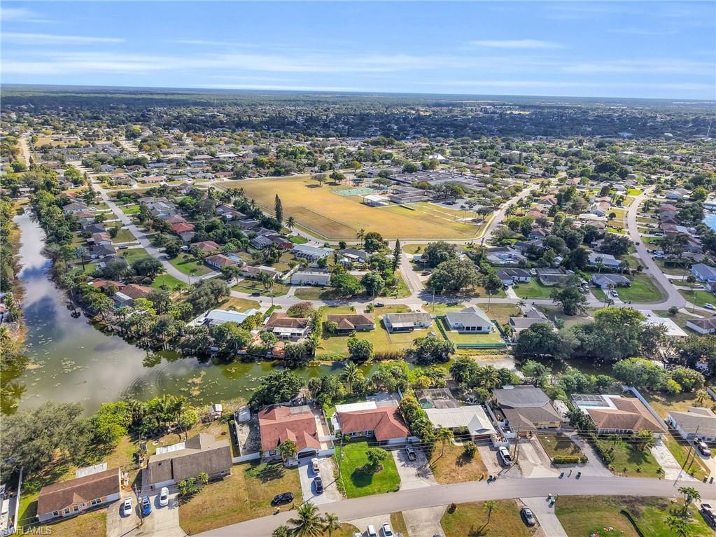 4991 18th Court Southwest Naples, FL 34116 - Photo 36 of 36 an aerial view of a city with lots of residential buildings and lake view in back