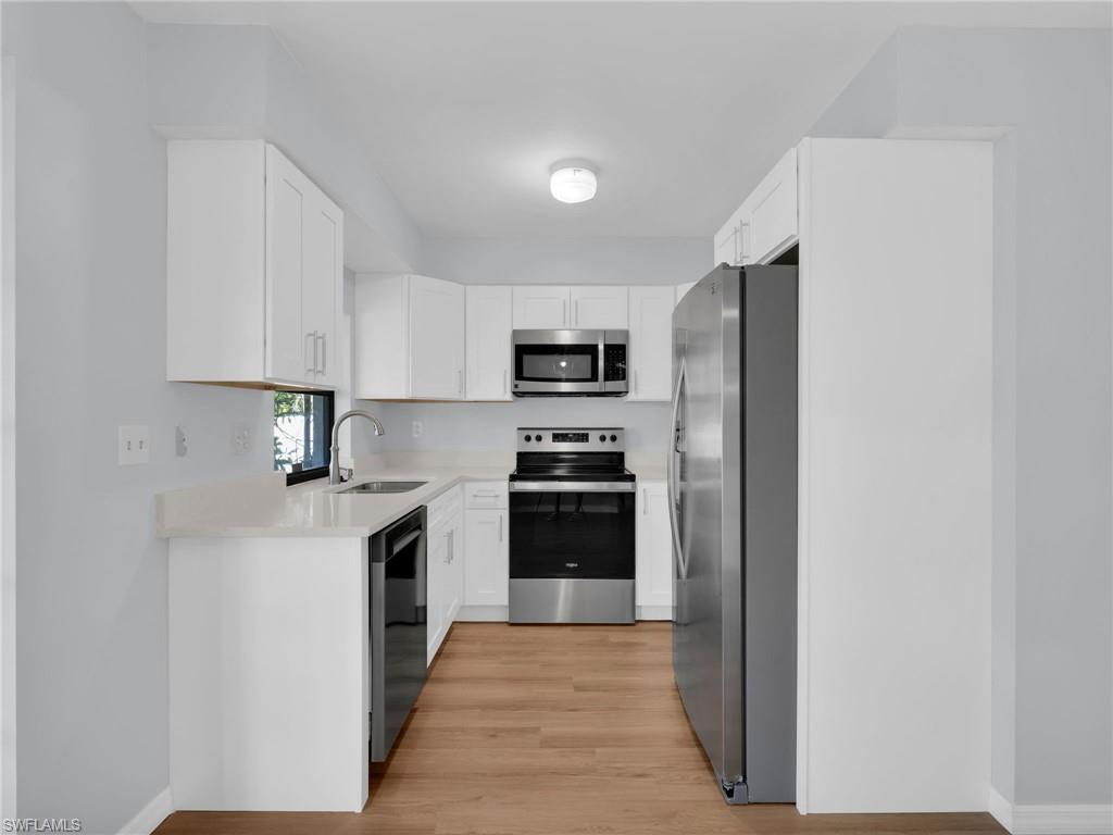 4991 18th Court Southwest Naples, FL 34116 - Photo 4 of 36 a kitchen with stainless steel appliances granite countertop a refrigerator a stove top oven a sink and dishwasher