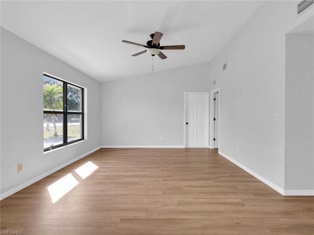 4991 18th Court Southwest Naples, FL 34116 - Photo 8 of 36 a view of empty room with wooden floor and fan
