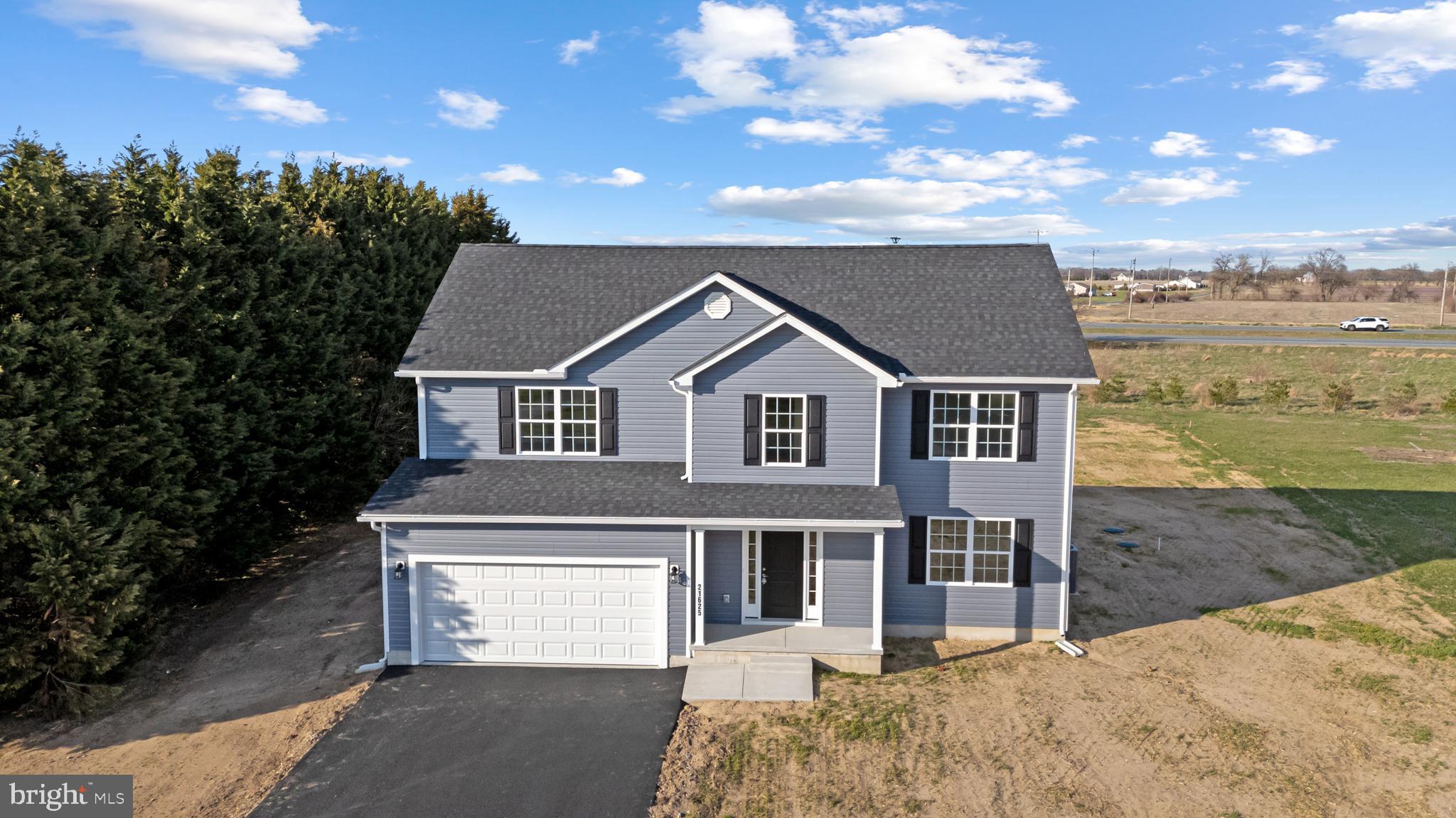 a view of a house with a yard and sitting area