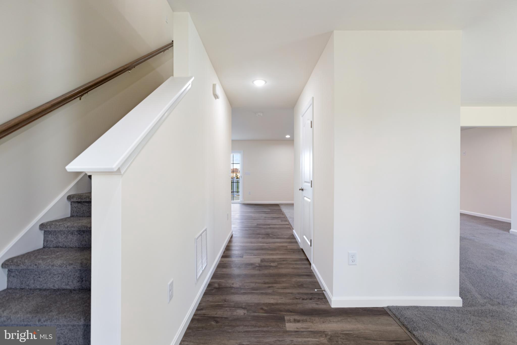 21625 Hackney Circle Lincoln, DE 19960 - Photo 14 of 46 a view of a hallway with wooden floor and staircase