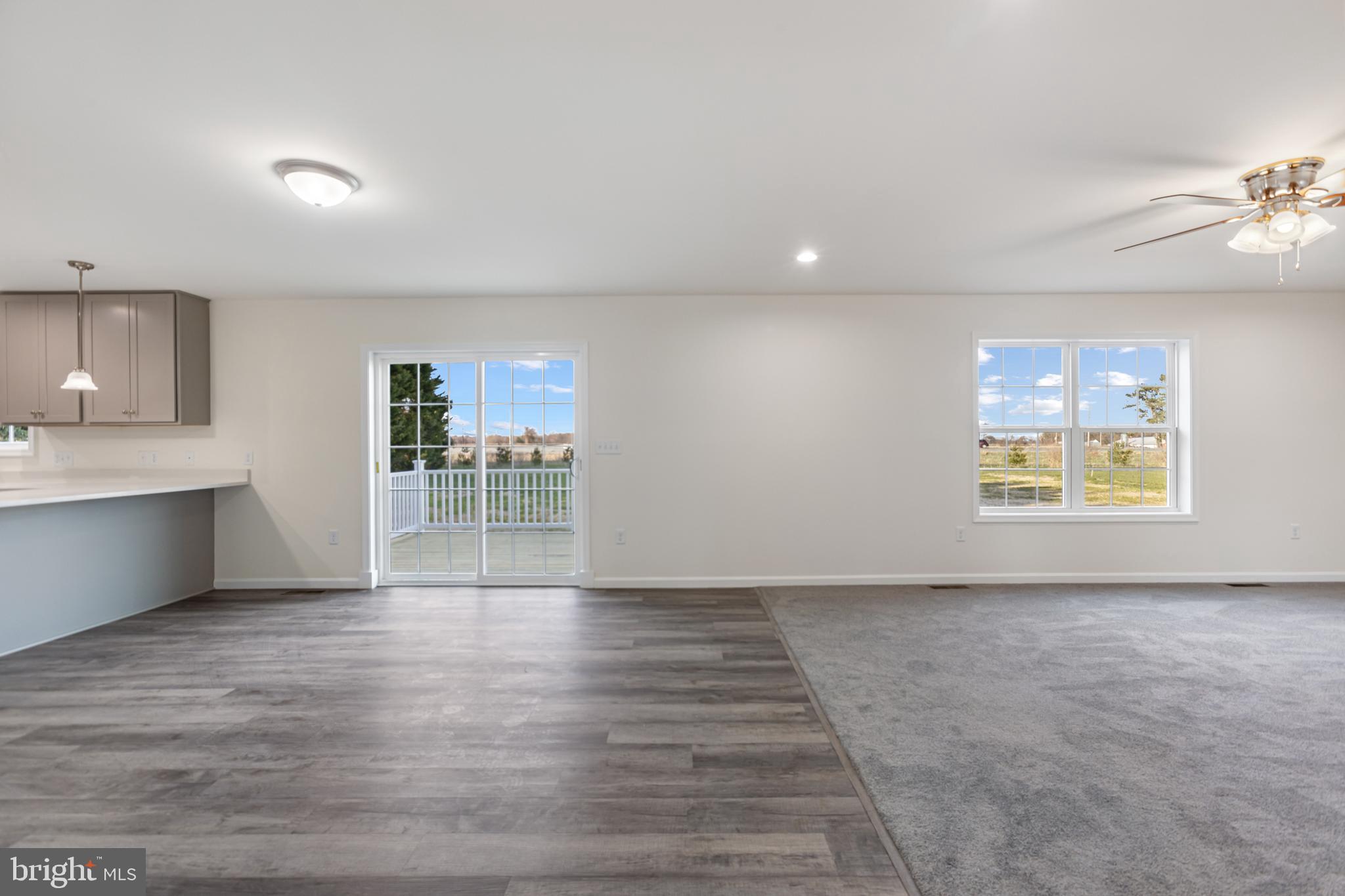 21625 Hackney Circle Lincoln, DE 19960 - Photo 17 of 46 a view of an empty room with a window and wooden floor