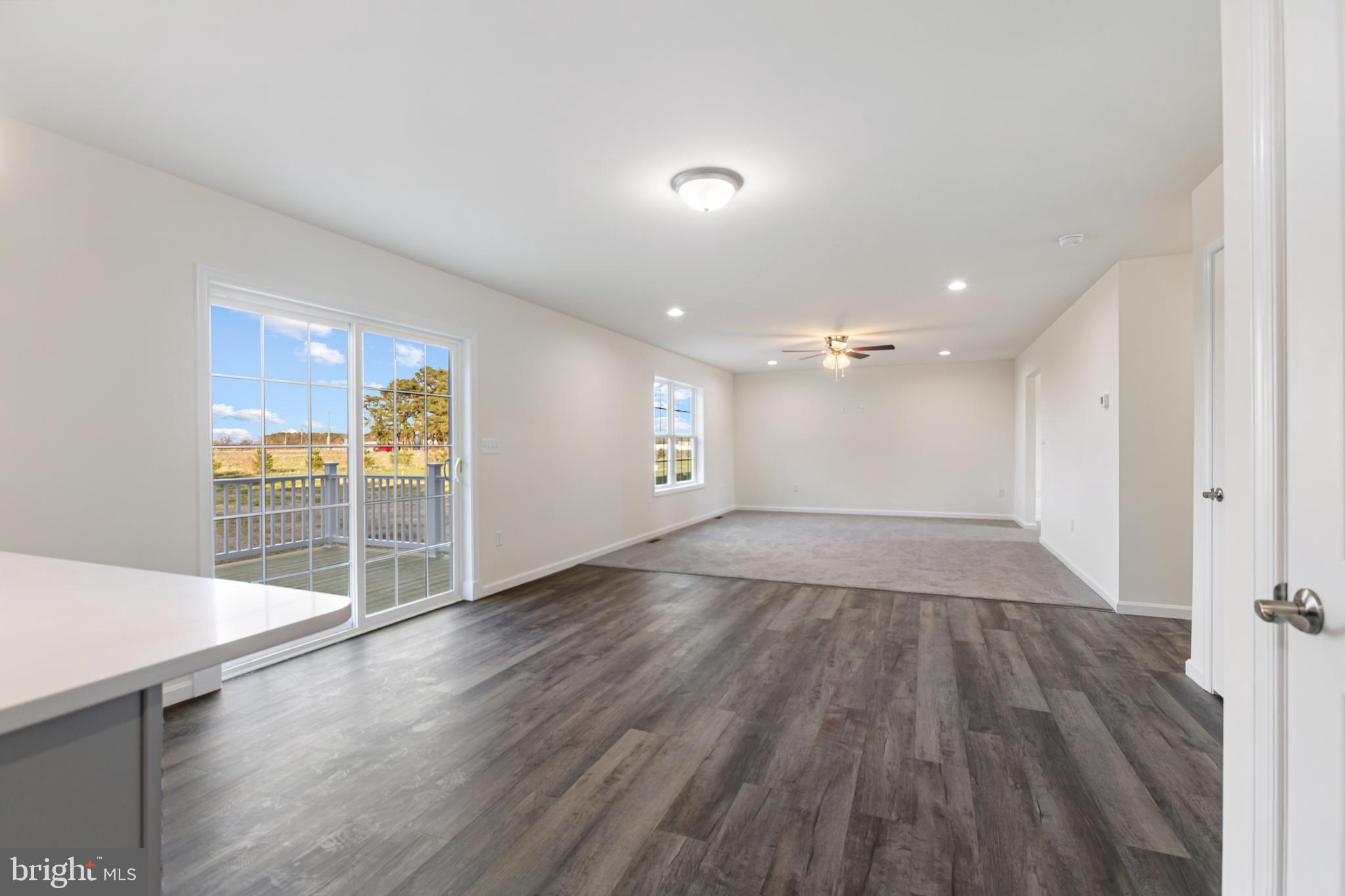 21625 Hackney Circle Lincoln, DE 19960 - Photo 21 of 46 an empty room with wooden floor and windows