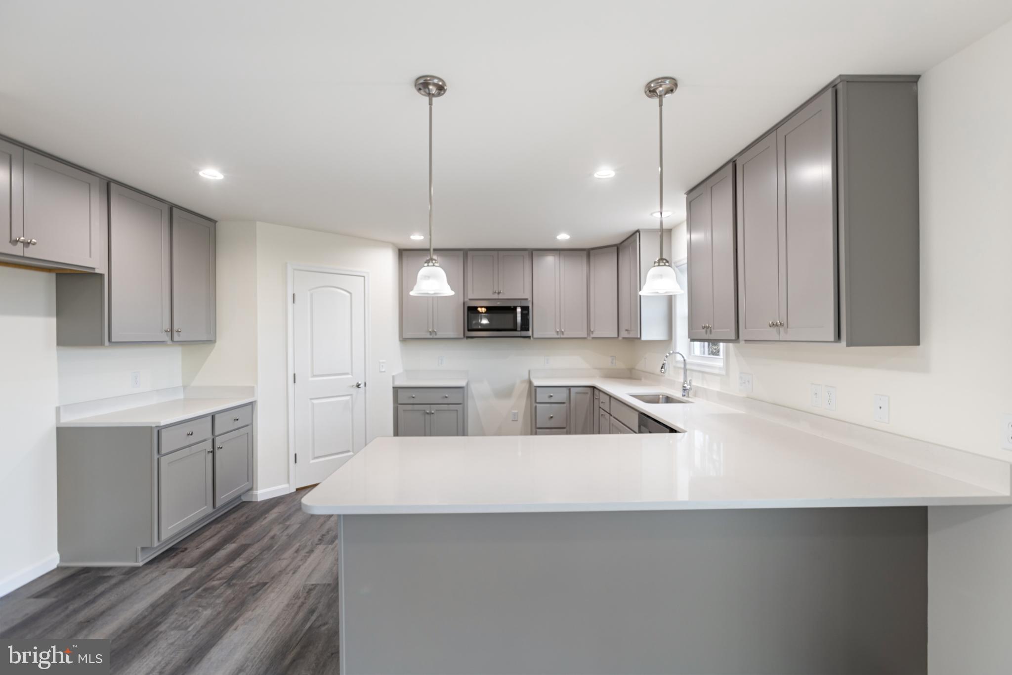 21625 Hackney Circle Lincoln, DE 19960 - Photo 23 of 46 a large kitchen with kitchen island a sink stainless steel appliances and cabinets