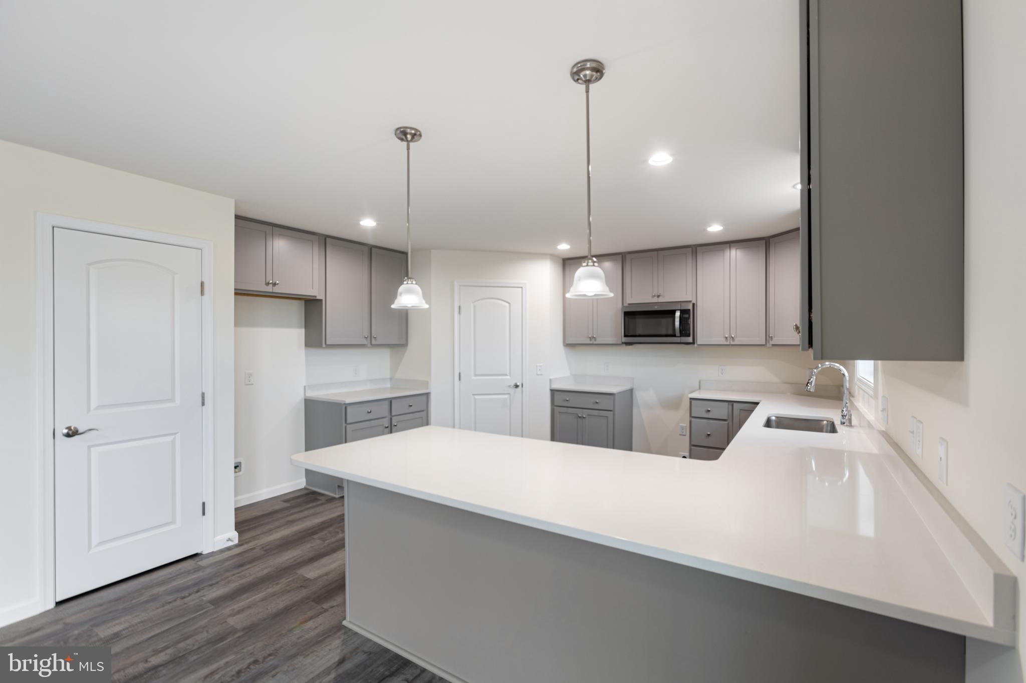 21625 Hackney Circle Lincoln, DE 19960 - Photo 24 of 46 a view of a kitchen with kitchen island a sink stainless steel appliances and cabinets