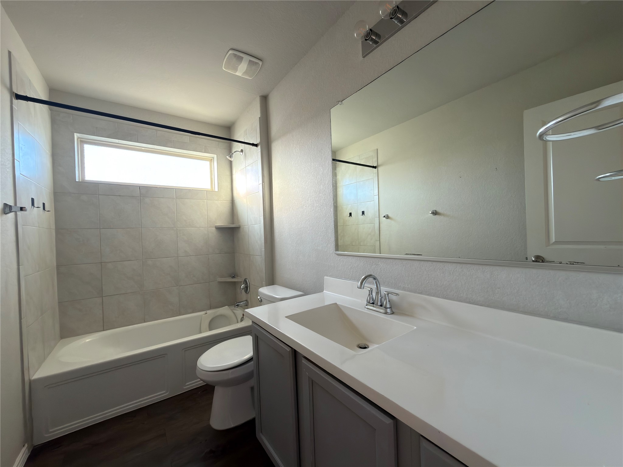 21700 Urraca Lane Pflugerville, TX 78660 - Photo 21 of 40 Full bathroom featuring bathing tub / shower combination, vanity, and dark wood-style flooring