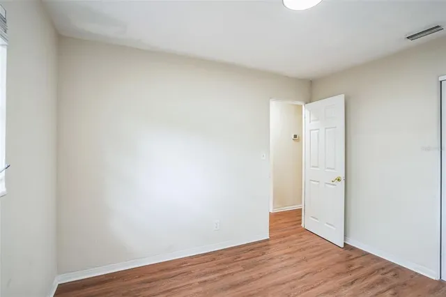 a view of an empty room and wooden floor