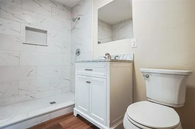 a white toilet sitting next to a bath tub shower