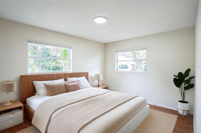 a bedroom with a bed and a potted plant