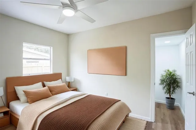 a bedroom with a bed and a potted plant