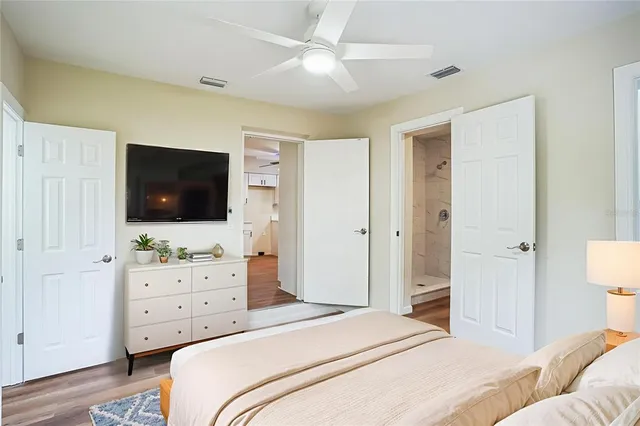 a bedroom with a bed and a flat screen tv