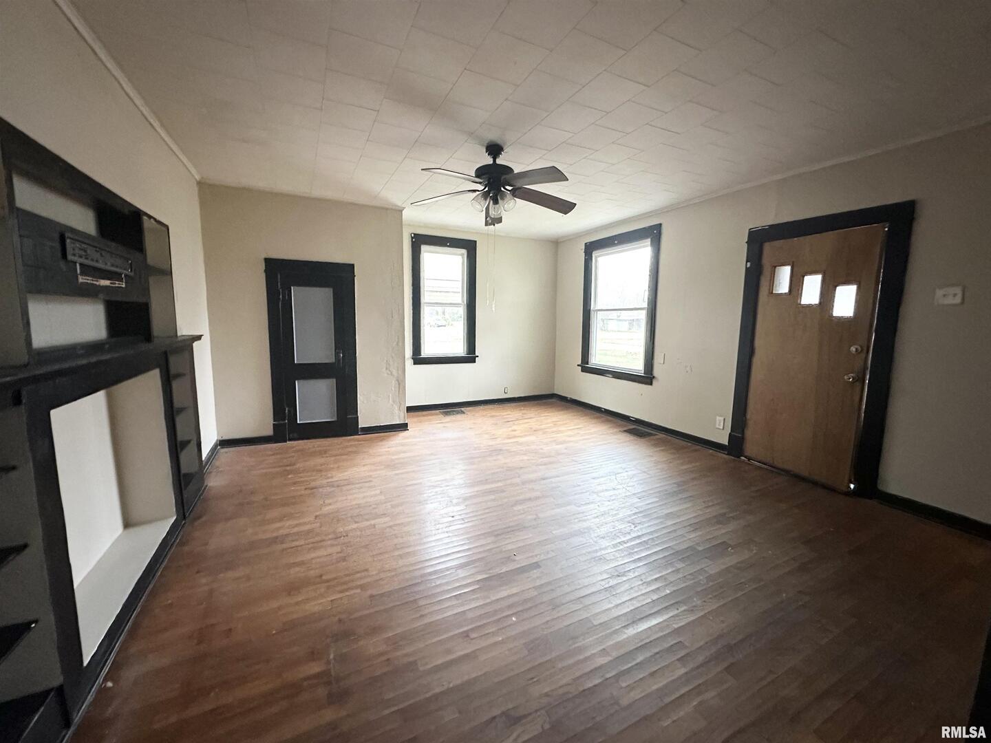 103 East 11th Street Belle Rive, IL 62810 - Photo 21 of 25 an empty room with wooden floor and windows