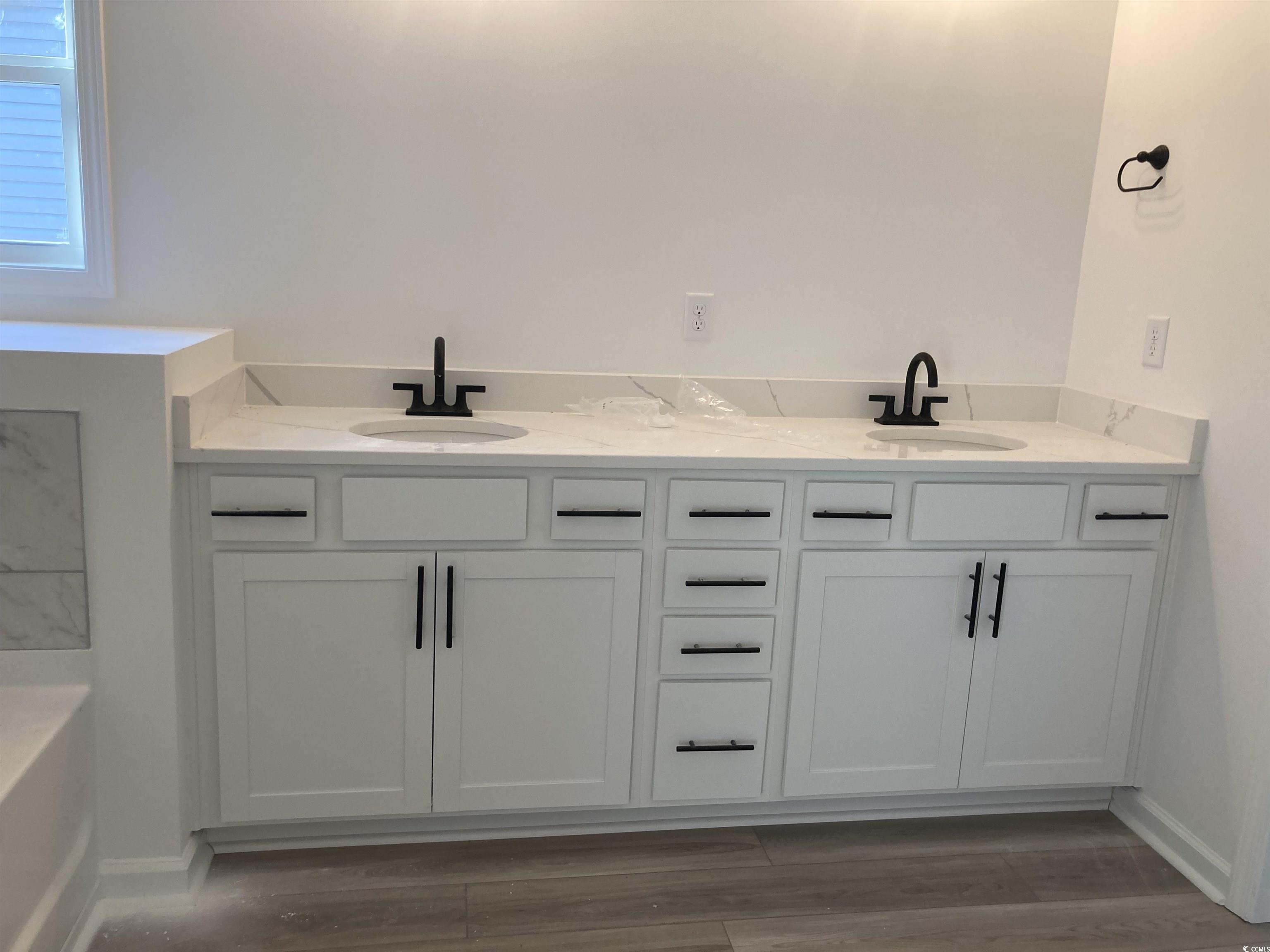 137 River Birch Drive Loris, SC 29569 - Photo 6 of 17 Bathroom with double vanity, light wood-style flooring, and a tub