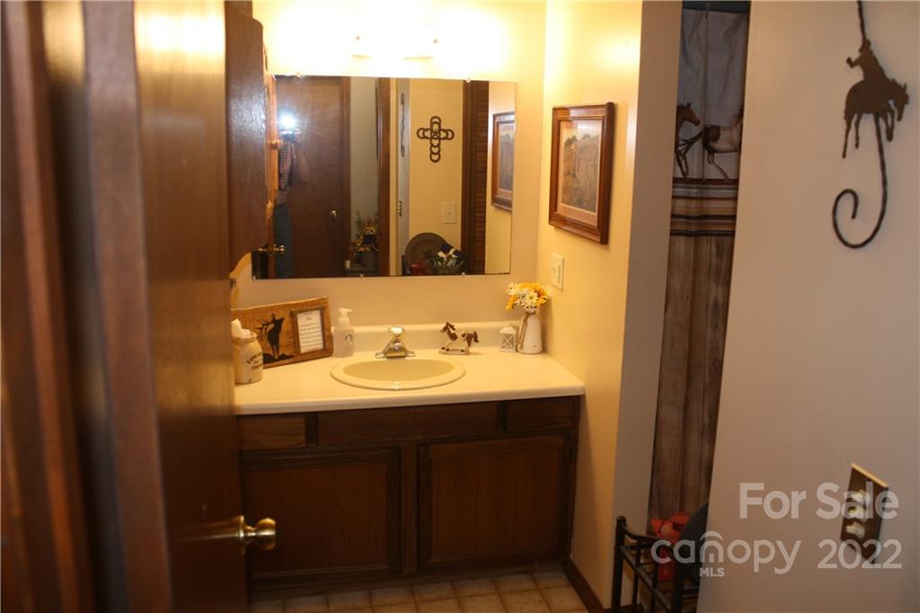 33 Fernbrook Road Maggie Valley, NC 28751 - Photo 12 of 36 a bathroom with a sink and a mirror