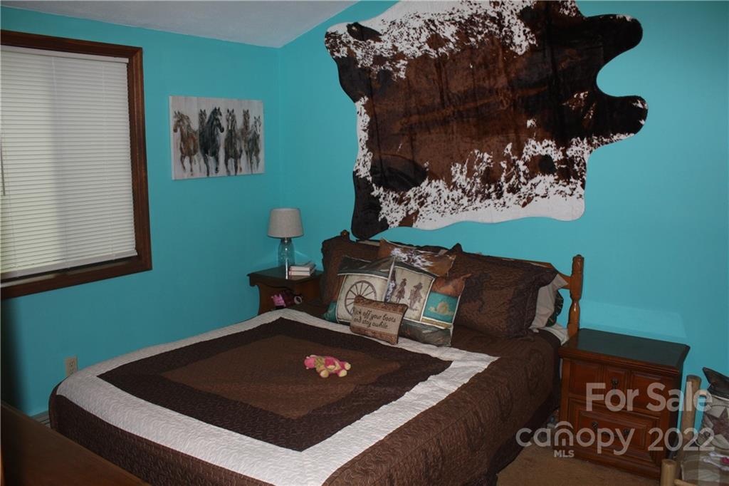 33 Fernbrook Road Maggie Valley, NC 28751 - Photo 18 of 36 a living room with furniture and a wall painting