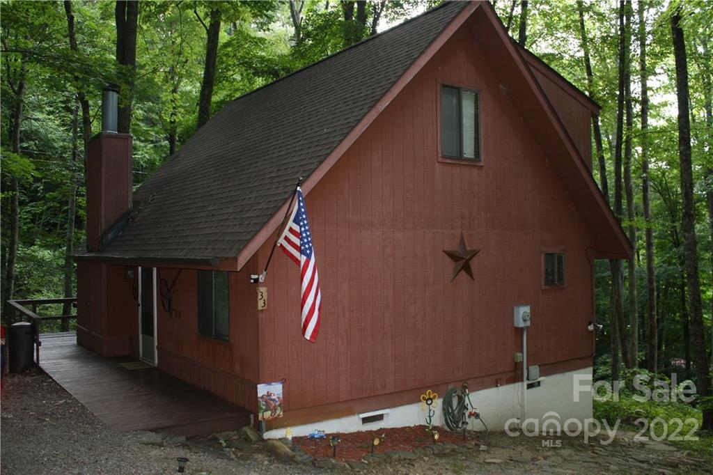 33 Fernbrook Road Maggie Valley, NC 28751 - Photo 2 of 36 a backyard of a house with lots of green space