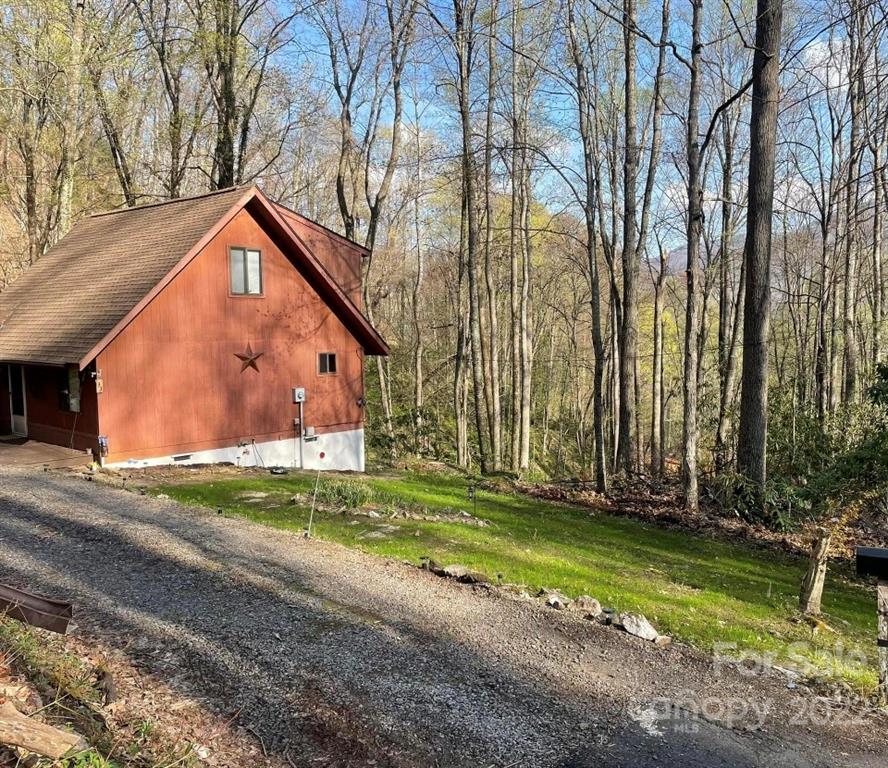 33 Fernbrook Road Maggie Valley, NC 28751 - Photo 3 of 36 a backyard of a house with lots of green space