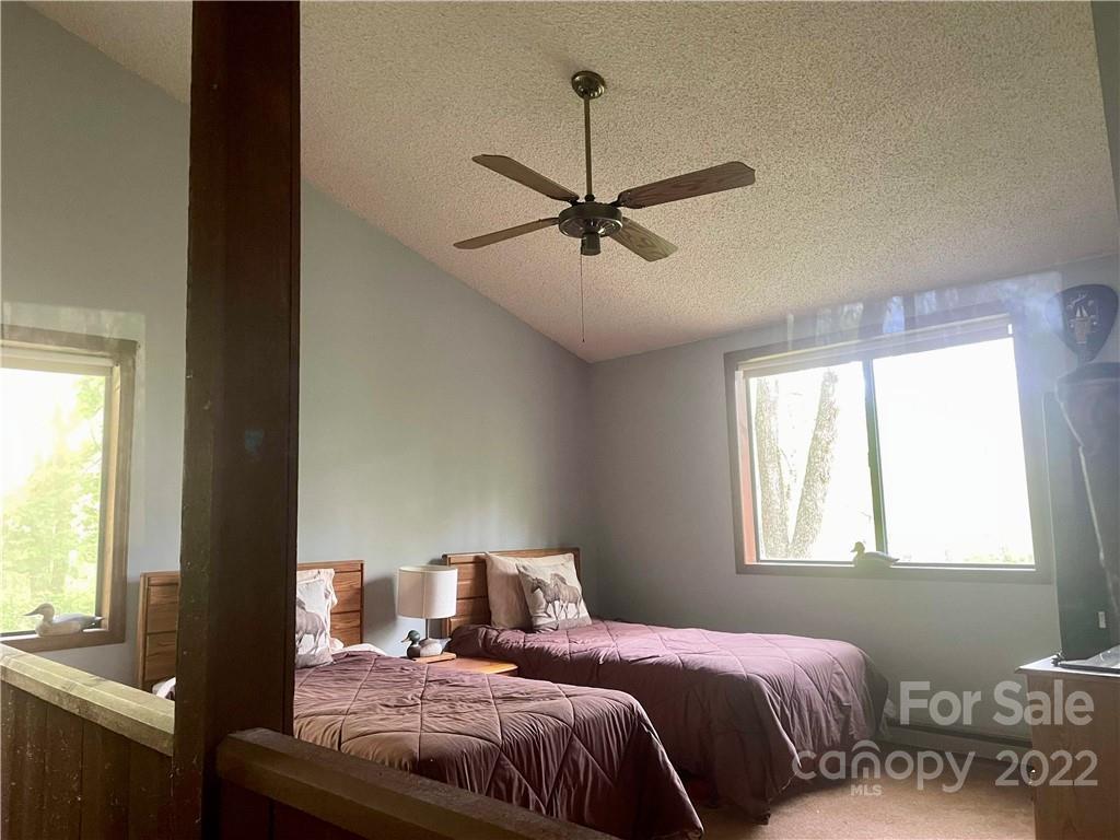 33 Fernbrook Road Maggie Valley, NC 28751 - Photo 31 of 36 a bedroom with a large bed and a window