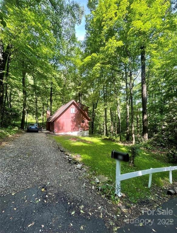 33 Fernbrook Road Maggie Valley, NC 28751 - Photo 32 of 36 a backyard of a house with trees and outdoor seating