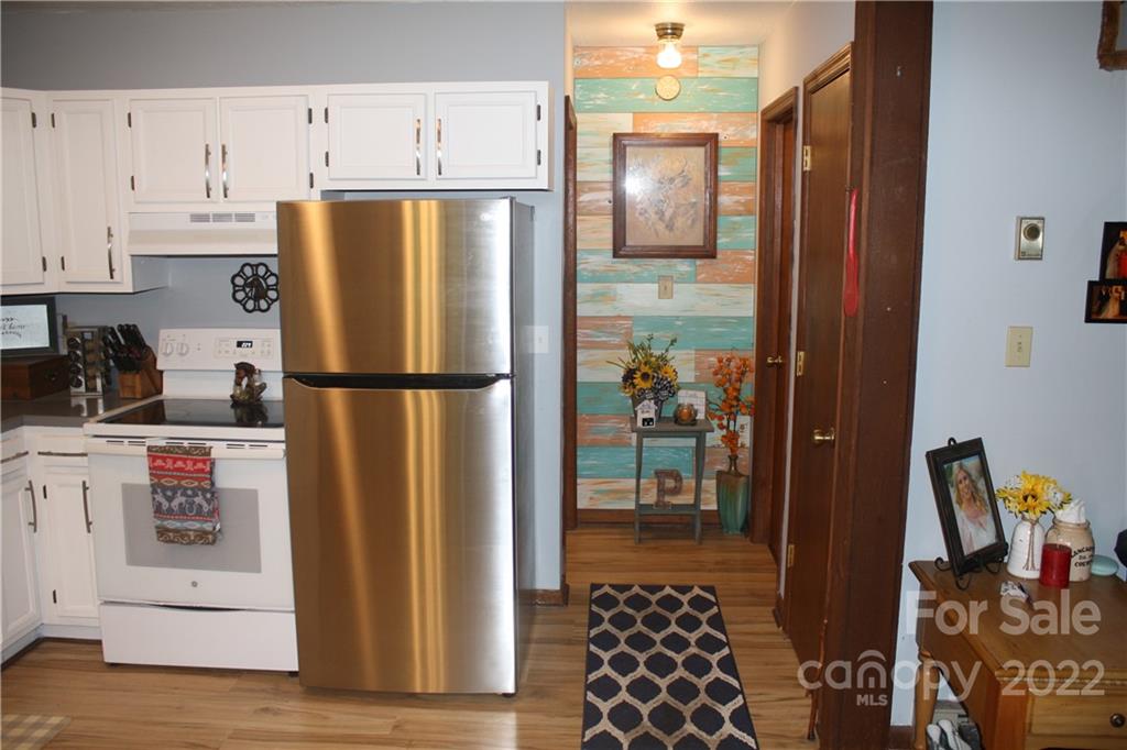 33 Fernbrook Road Maggie Valley, NC 28751 - Photo 7 of 36 a kitchen with stainless steel appliances granite countertop a refrigerator and a stove