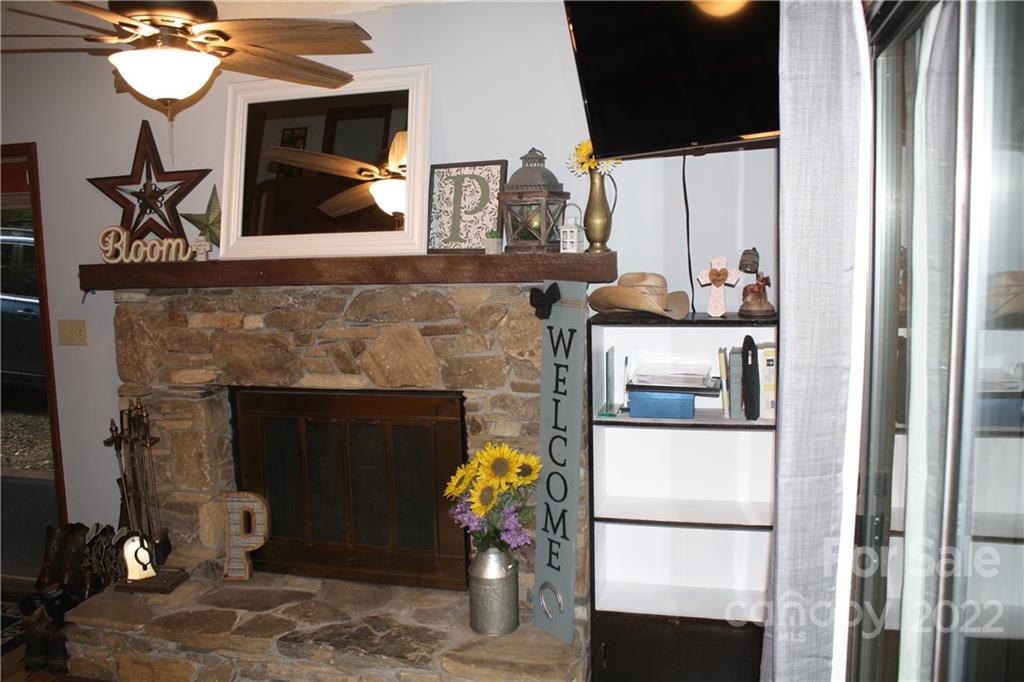 33 Fernbrook Road Maggie Valley, NC 28751 - Photo 9 of 36 a living room with furniture and a fireplace