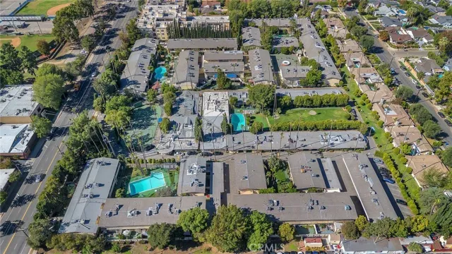 an aerial view of multiple houses with yard