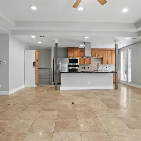 a view of a kitchen with a sink and cabinets