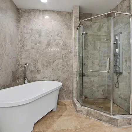 a bathroom with a bathtub and a shower