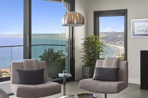 a living room with furniture and a potted plant