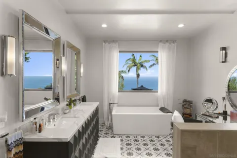 a bathroom with a granite countertop sink mirror and a bathtub