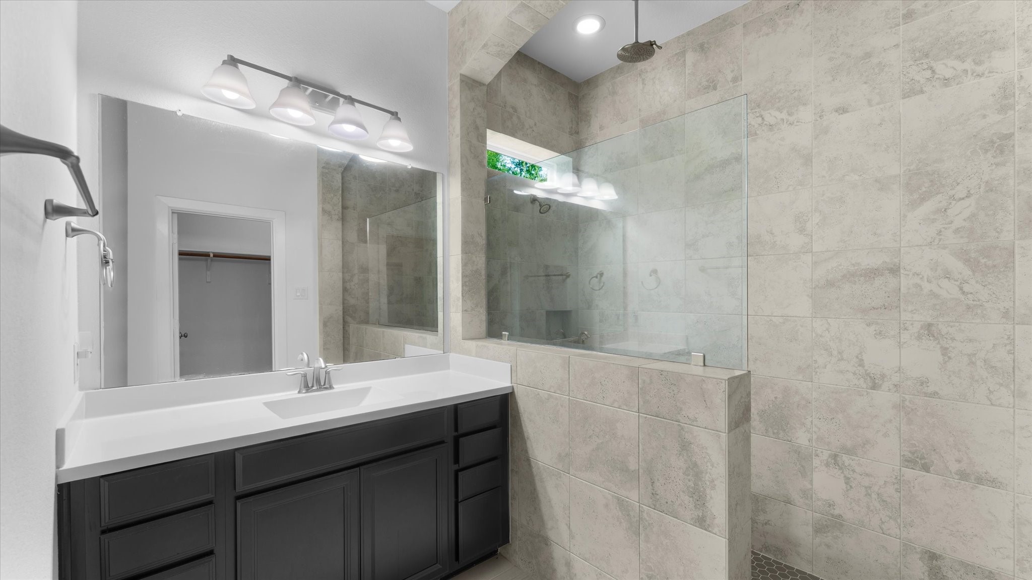 32001 Birch Briar Court Spring, TX 77386 - Photo 31 of 48 Beautiful en-suite secondary bathroom featuring granite countertops, designer cabinetry, and a fully tiled walk-in shower.