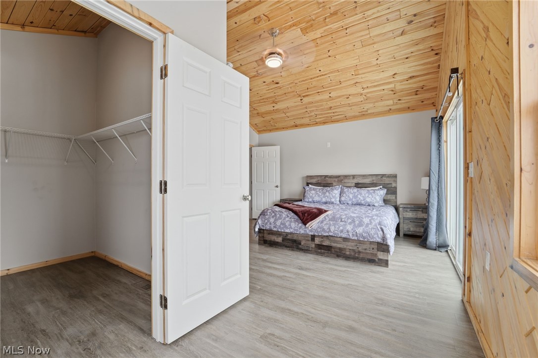 5919 Lake Road West, Unit 33 Ashtabula, OH 44004 - Photo 16 of 22 Bedroom with a vaulted wooden ceiling and light wood-type flooring